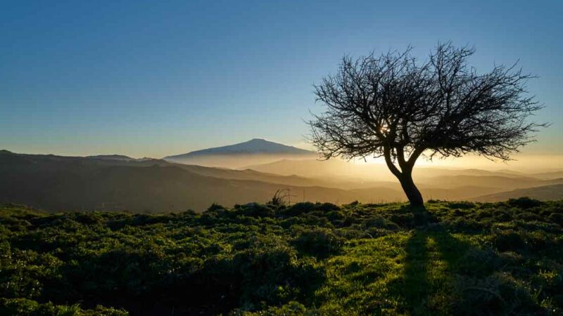 Vanlife-Szene in Sizilien. Aussicht vom Campspot auf Sonnenaufgang und Ätna.